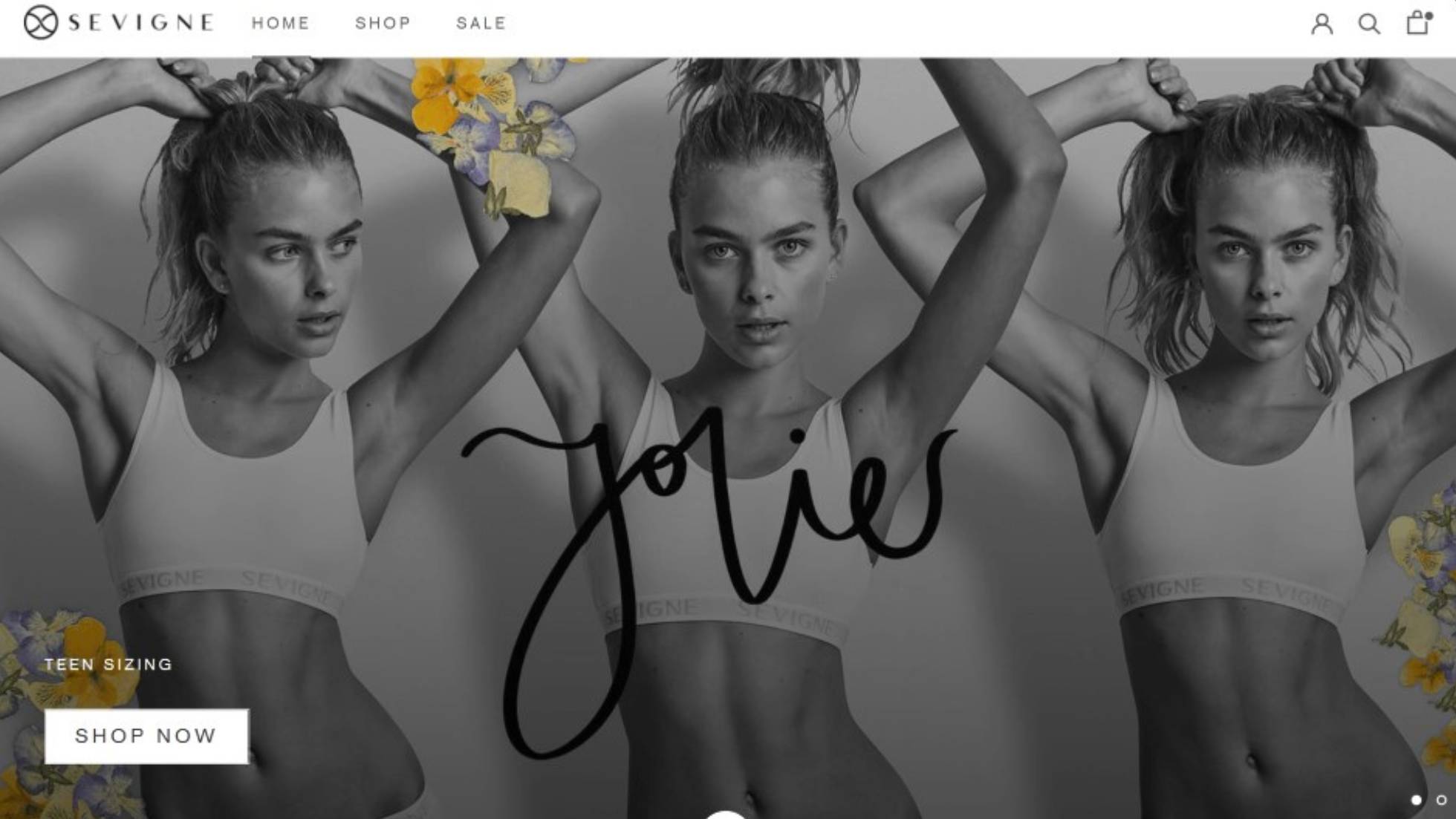A Photo of the Creato's Ecommerce web design case study of Sevigne a clothing brand in Sydeny, with three women posing in a black and white photo wearing a white tank top and the word ‘Jolie’ on them, and a ‘Shop Now’ button for teen sizing. 